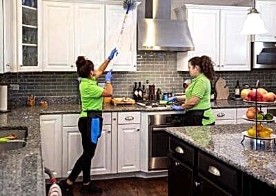 Stove top and cabinets cleaned and wiped | Helping Hands Cleaning Services