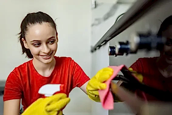 happy-woman-with-bottle-spray-cleanser-cleaning-oven-home-kitchen