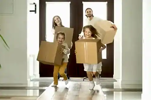 Family Holding Boxes | Helping Hands Cleaning Services | Move-in Cleaning Service